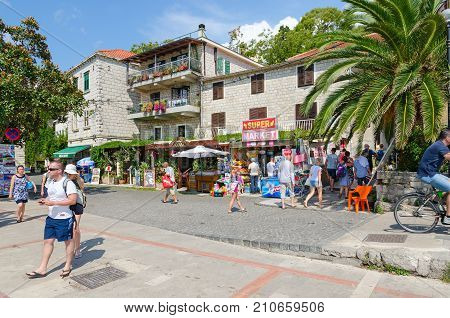 HERCEG NOVI MONTENEGRO - SEPTEMBER 10 2017: Unknown tourists walk along promenade in popular resort town of Herceg Novi Montenegro