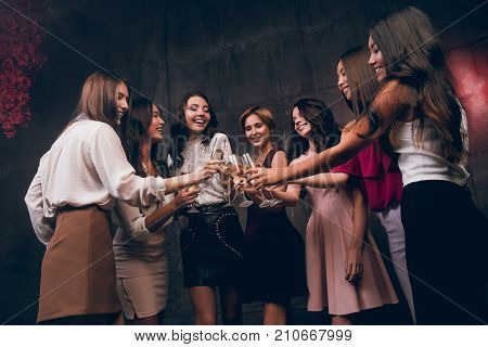 Celebrate New Year party. Company of beautiful girls with glasses of champagne celebrate New Year and happy smiling.