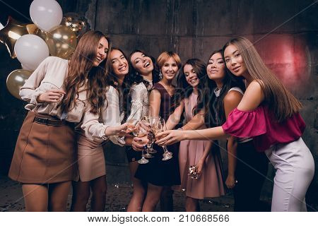 Beautiful girlfriends looking at the camera and smiling. Celebrate Christmas Ewe in the club with friends. New Year holiday with best friends.