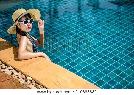 Women wearing bikini or swimware suits at swimming pool at the resort of Pattaya in Thailand.