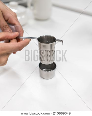 Woman Hands Holding Stainless Steel Tea Infuser With Dish Set
