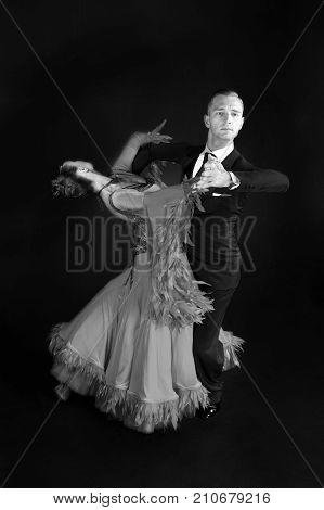 dance ballroom couple in dress dance pose isolated on black background. sensual professional dancers dancing walz tango slowfox and quickstep.