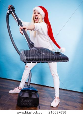 Angry Girl In Santa Helper Hat With Vacuum Cleaner