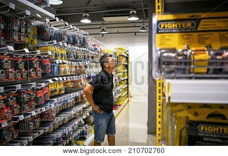 BANGKOK THAILAND - OCTOBER 22: Customer shops for locks in the aisle in Mr. DIY hardware store located in Victoria Garden in Bangkok on October 22 2017