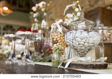 white sugared almond in glass jar on table