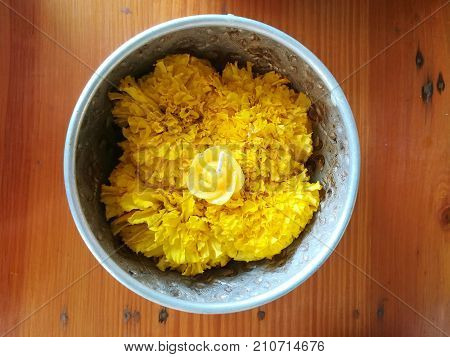 Marigold flowers and candle for making merit in Buddhism
