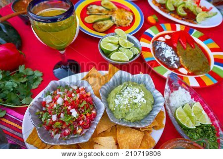 Mexican recipes mix on a colorful table with sauces from Mexico
