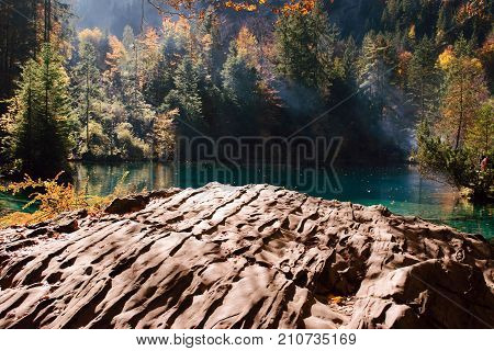 Autumn time at romantic forest lake Blausee, one of the best known mountain lakes in Switzerland.