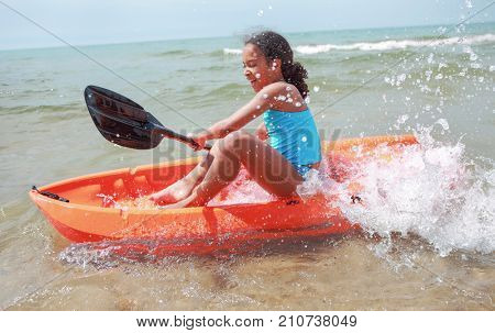 Young girl Kayaking at the beach