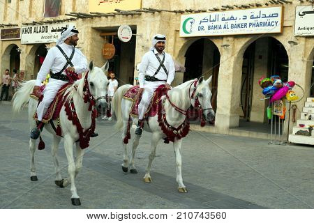 DOHA, QATAR - OCTOBER 23, 2017: Shoppers in the main thoroughfare of Souq Waqif market in Qatar, Arabia