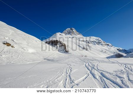 Alpine winter mountain landscape. French Alps covered with snow in sunny day. Val-d'Isere, France