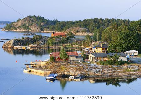 KRISTIANSAND ARCHIPELAGO, NORWAY ON JULY 01. View over bridges, boats and lodges by a little harbor on July 01, 2009 in Kristiansand archipelago, Norway. Calm summer evening. Editorial use.