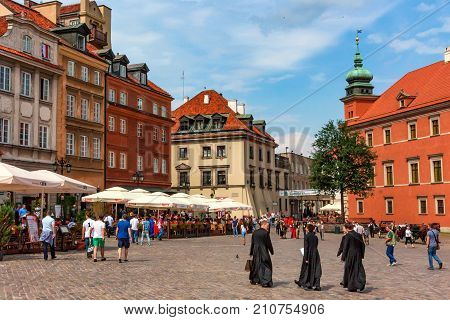 WARSAW, POLAND - JUNE, 2012: Beautiful view of Old Town market place on sunny day with lots of tourists