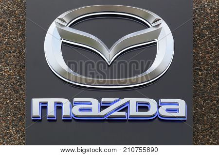Skanderborg, Denmark - October 21, 2017: Mazda logo on a facade. Mazda is a Japanese automaker based in Fuchu, Japan