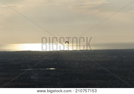 View of a paragliding practice at the sunset