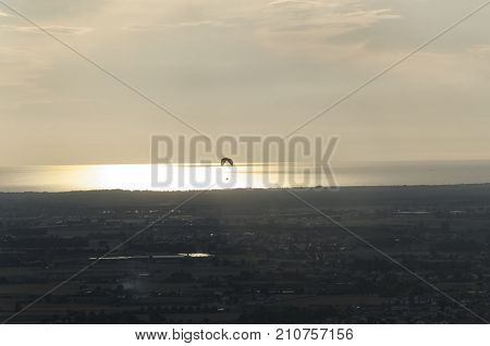 View of a paragliding practice at sunset