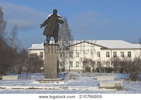 Velsk, Arkhangelsk region, Russia - November 6, 2016: Monument to Vladimir Ilyich Lenin on the background of school number 3 in the town of Velsk