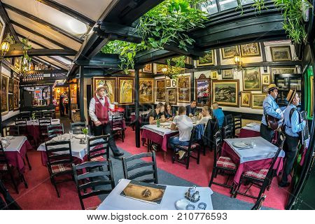 BELGRADE SERBIA - OCTOBER 21 2017: Interior with paintings on restaurant walls located in the old street Skadarlija the main bohemian place of Belgrade.