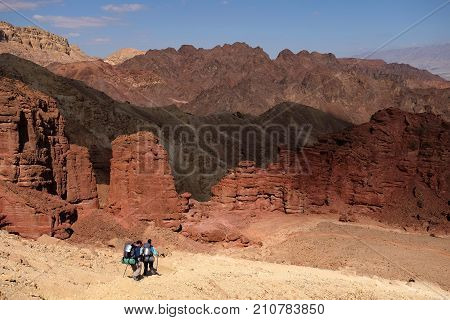 Unrecognized couple of hikers on scenic trail in Eilat Mountains Israel.