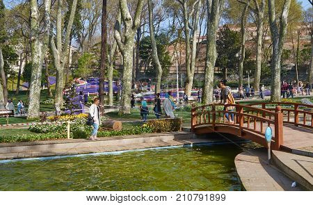 Istanbul Turkey - April 06 2016 Annual Spring Festival of Tulips new design Gulhane Park local people and tourists are getting rest making photos and enjoy good weather and spring slice of life editorial.