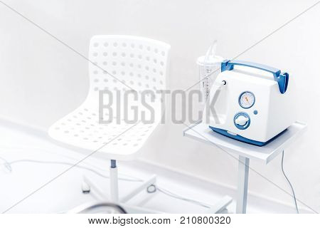 Chair And Medical Device In Hospital Room. Blood Pressure And Oxygen Ventilation Device