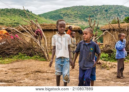 MASAI MARA, KENYA - OCTOBER 17, 2014: Two african boys from Masai tribe in their village. The Maasai are a Nilotic ethnic group living in southern Kenya and northern Tanzania.
