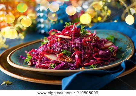 Red Cabbage salad with apples and pecan nuts for Christmas dinner. Vegetarian dish.