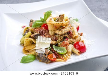 Traditional Italian pappardelle alla cozze with mushrooms and parmesan as close-up on a plate