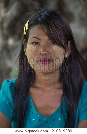 MANDALAY MYANMAR - SEP 03 : Portrait of Burmese girl with thanaka on face on Mandalay Myanmar on September 03 2017. Thanaka is paste made from ground bark