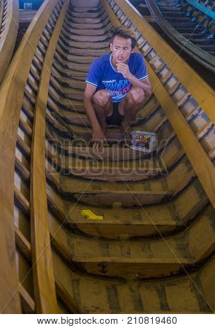 INLE LAKE MYANMAR - SEP 07 : A Burmese man building a boat in Inle lake Myanmar on September 07 2017 inle Lake is a freshwater lake located in Shan state