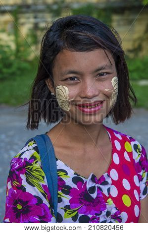MANDALAY MYANMAR - SEP 03 : Portrait of Burmese girl with thanaka on face on Mandalay Myanmar on September 03 2017. Thanaka is paste made from ground bark