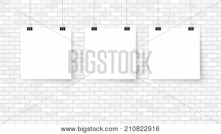 Poster on binder clips. Paper templates on brick wall. Realistic mock up. Empty frames for your business design. Brick wall. Vector template for lettering quote images or logos.