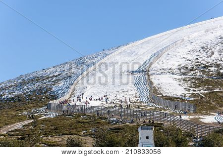 NAVACERRADA - JANUARY 4 2015: Tourists in Navacerrada Ski Resort Navacerrada Mountain Pass Madrid Spain on January 4 2015.