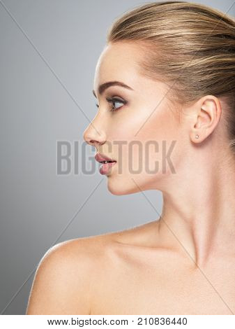 Profile face of  young  woman, skin care treatment. Side view of beautiful girl with healthy skin of the face