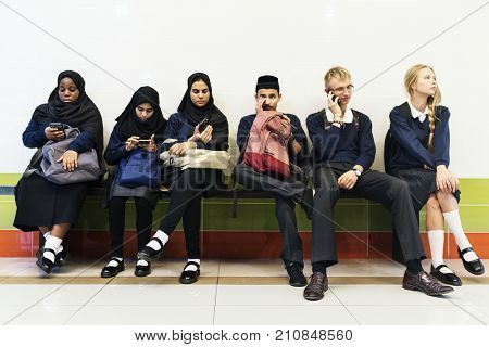 Group of diverse students using mobile phones