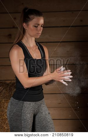 Active Young Fit Woman Claping Hands With Magnesium On Them Before Lifting Barbell Weights