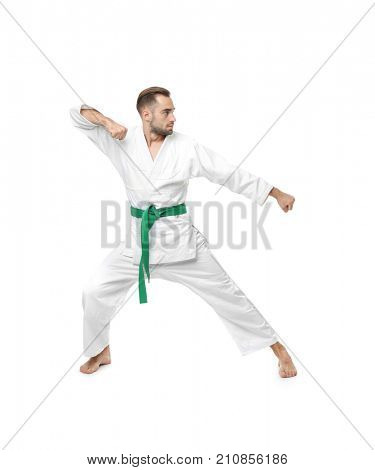 Young man practicing karate on white background