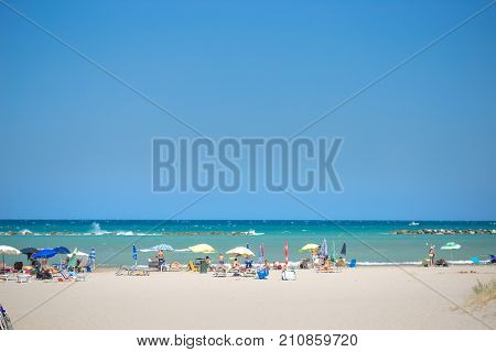 White Beaches Italy. Sea Sky People Umbrellas Sun Beds.