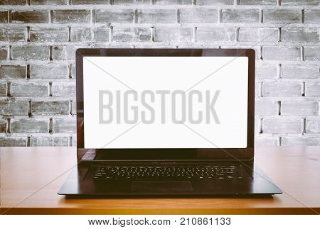 Open Laptop On An Office Desk In Front Of Brick Wall Background