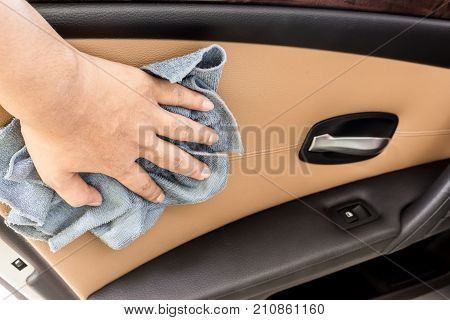 Hand With Microfiber Cloth Polishing In Car