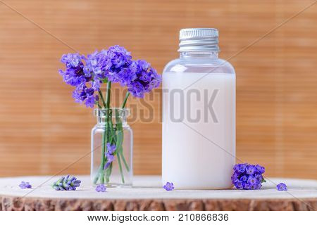 natural cosmetic bottle with fresh lavender flowers, selective focus