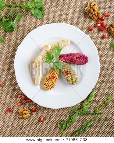 Georgian cuisine. Spinach appetizer phali with pomegranate seeds