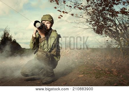 Photographer in war conflict field zone observing