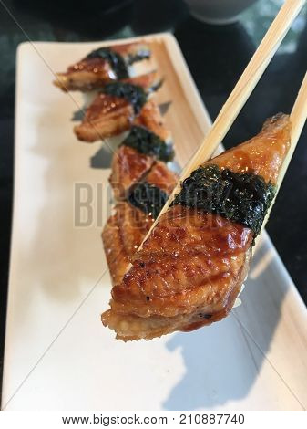 Unagi smoked eel sushi on chopstick japanese food