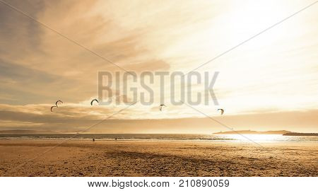 Kite surfers glide on the waves of the Atlantic ocean.Active leisure concept.Panoramic landscape