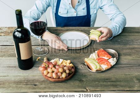 Female taster eating sandwich with zucchini vegetarian