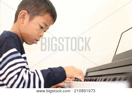 Japanese Boy Playing A Piano (second Grade At Elementary School)
