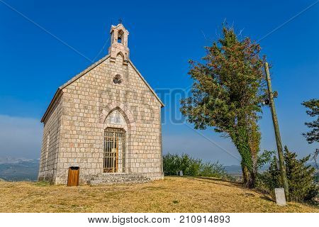Little stone church on hill above town Sinj was built in 1887, Croatia Europe.