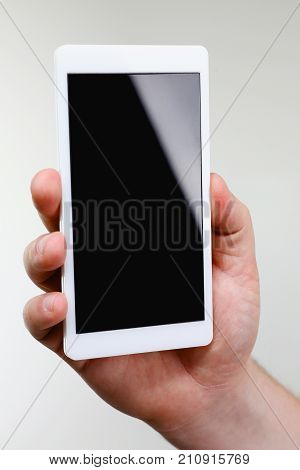 Male hand hoding smartphone isolated on white background. You can insert an image image of your text for the concept or project development of mobile applications and their advertising mobile devices