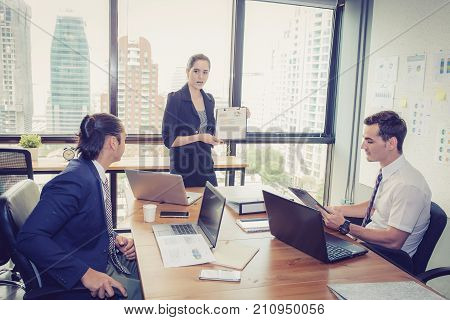 businesswoman presentation to a group in meeting.